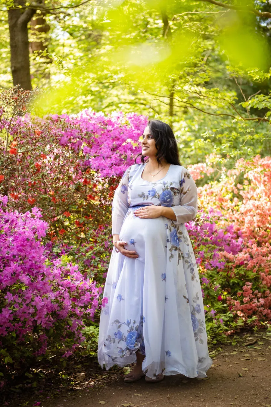 Pregnant woman holding her belly and smiling