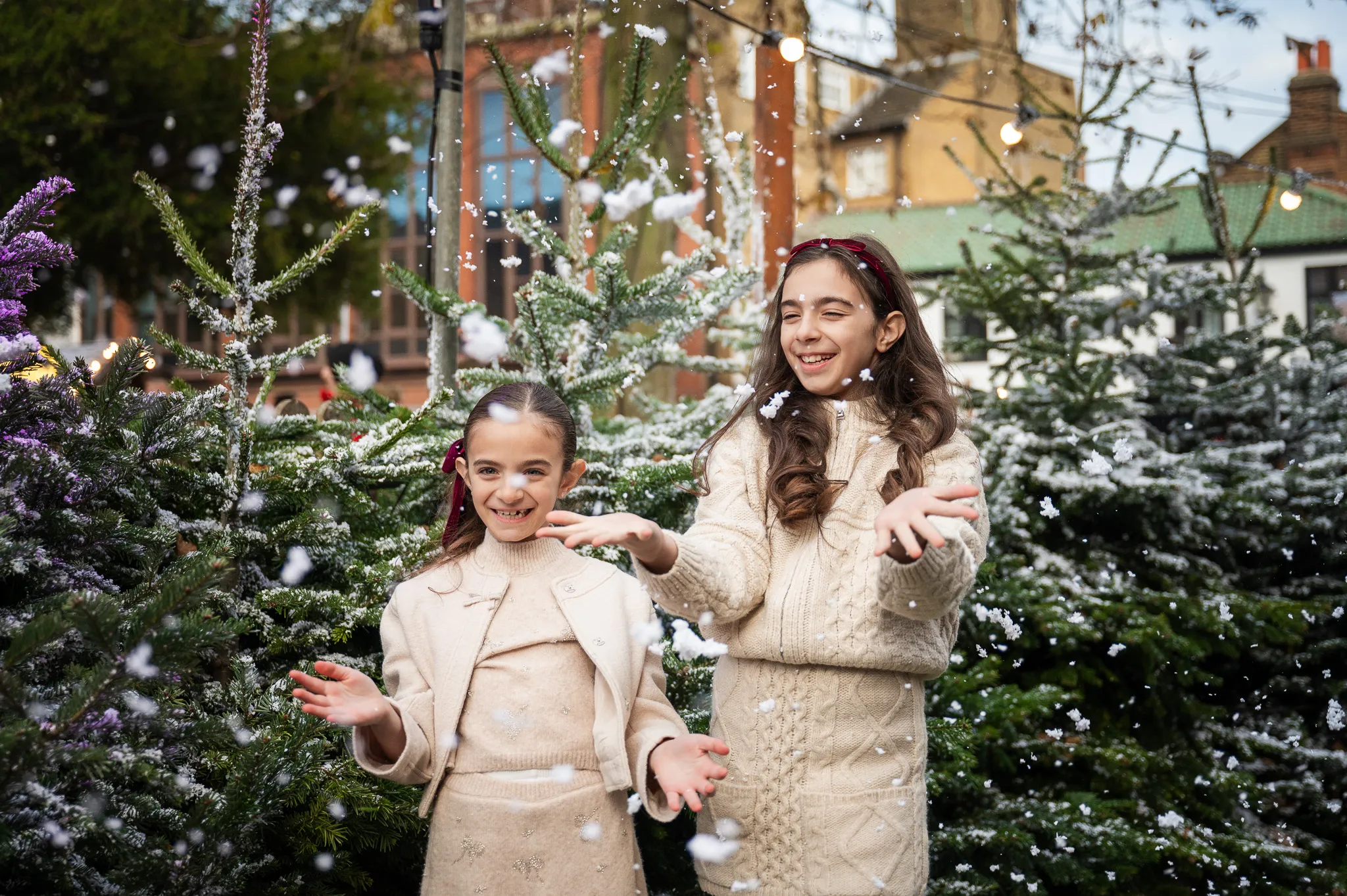 Sisters enjoying a moment in the Kingston Christmas market, capturing memories during their photoshoot.