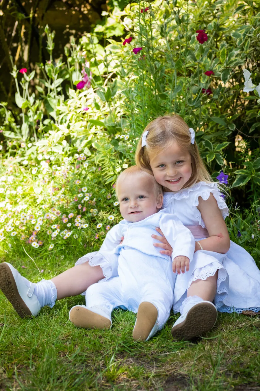 Little girl holding her baby brother for a family photoshoot