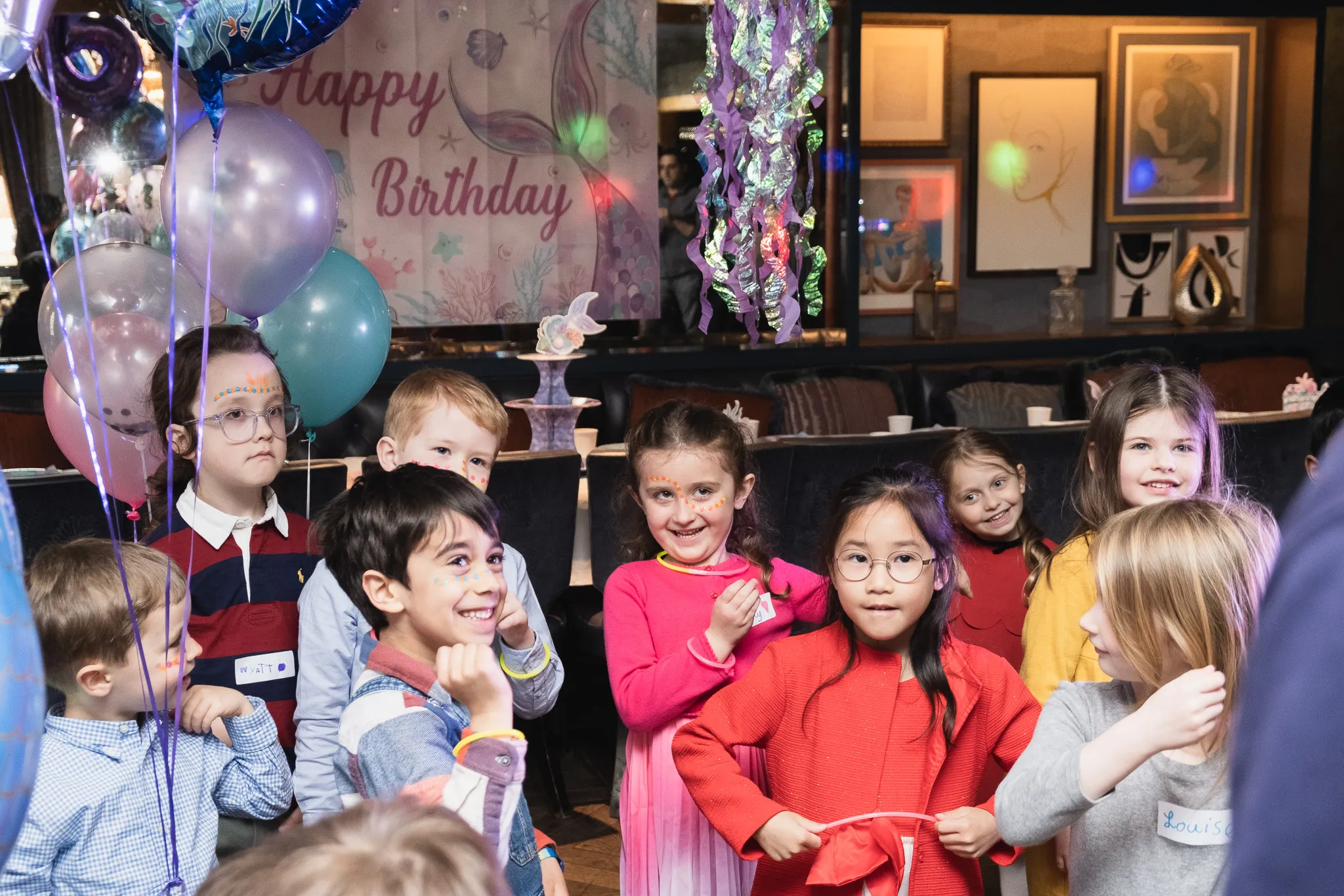 Children on a birthday party, birthday girl with her friends having fun