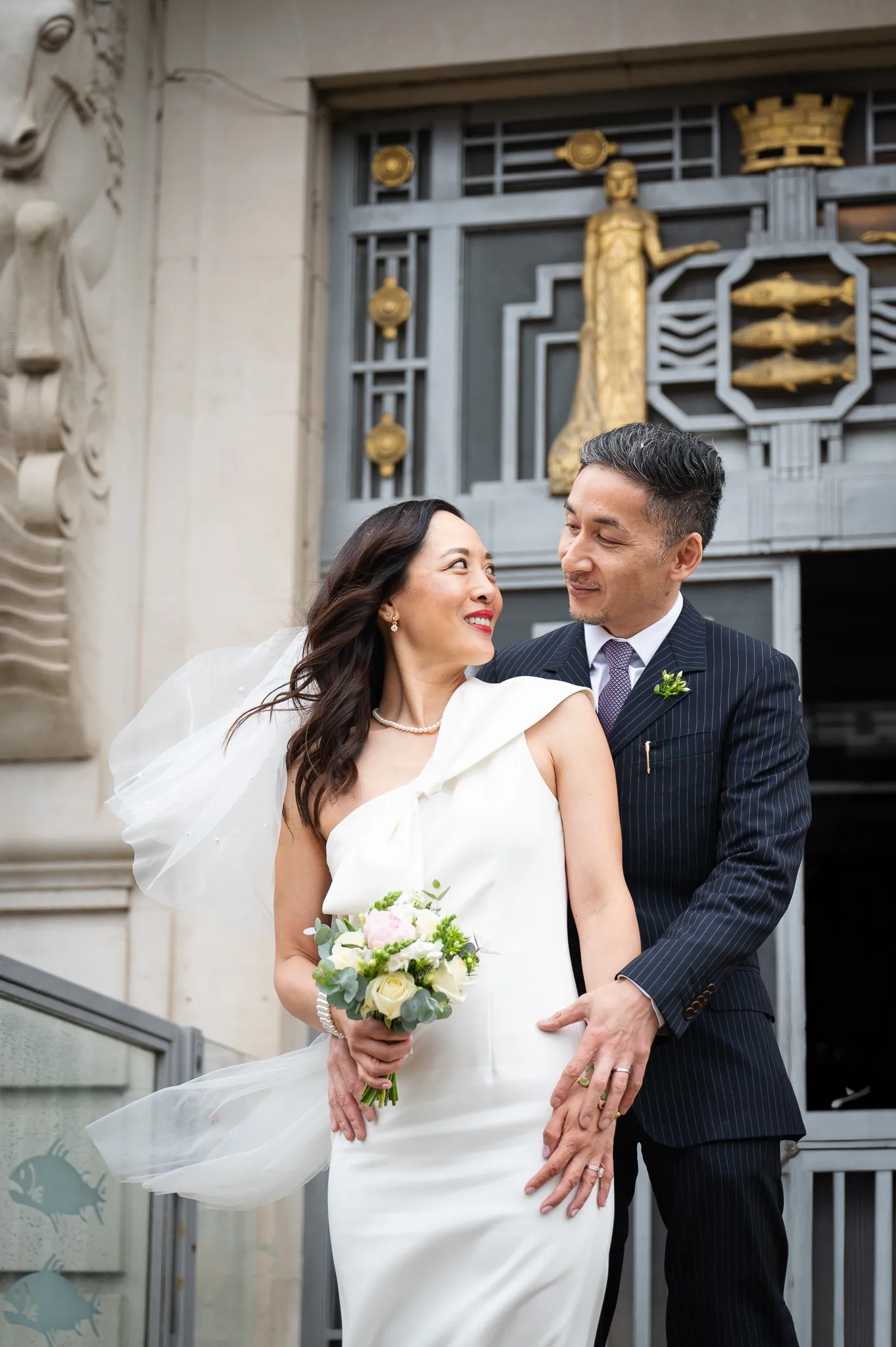 A couple at a wedding day looking at each other and smiling
