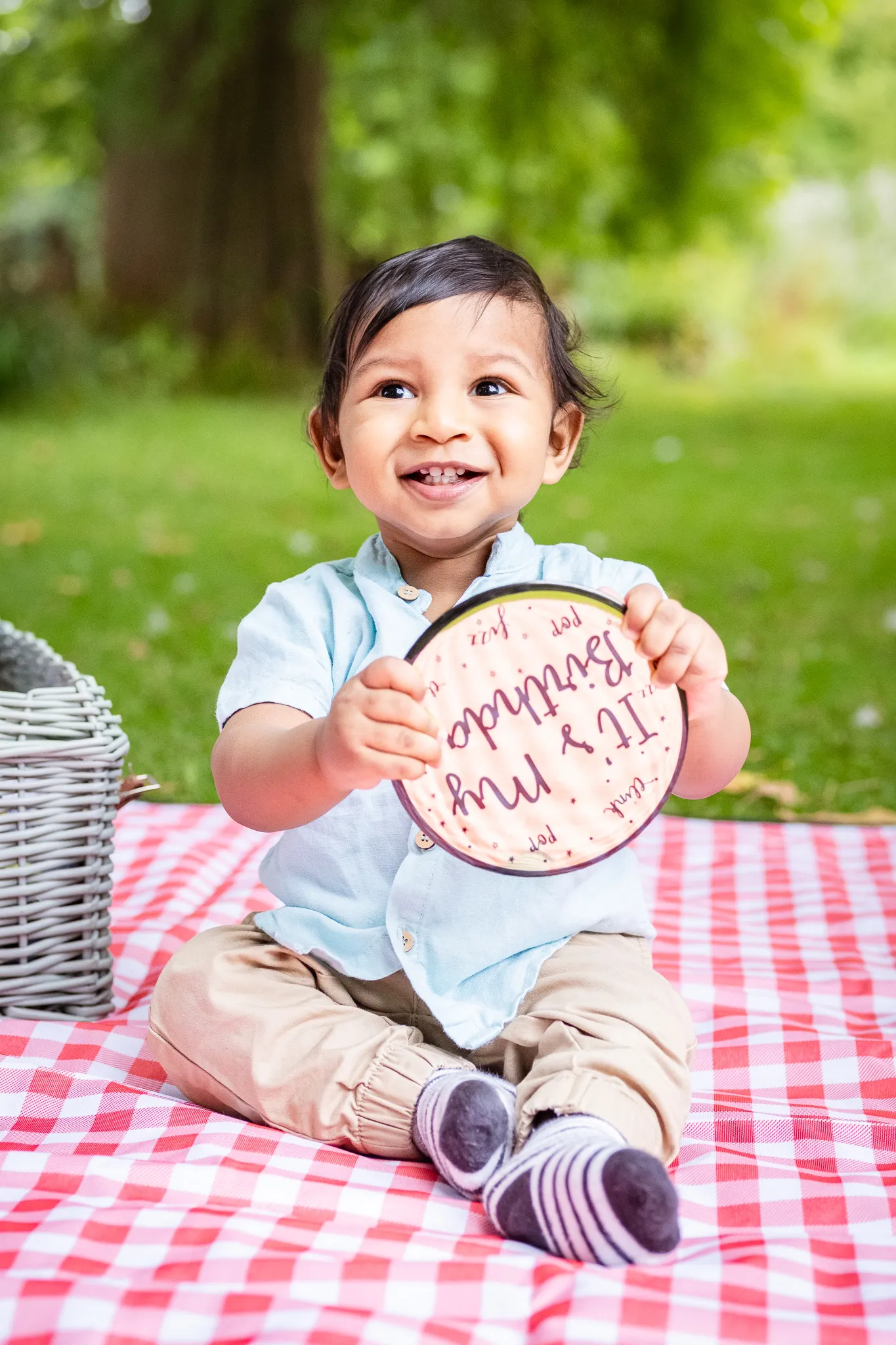 Little baby boy's first birthday photoshoot in a park