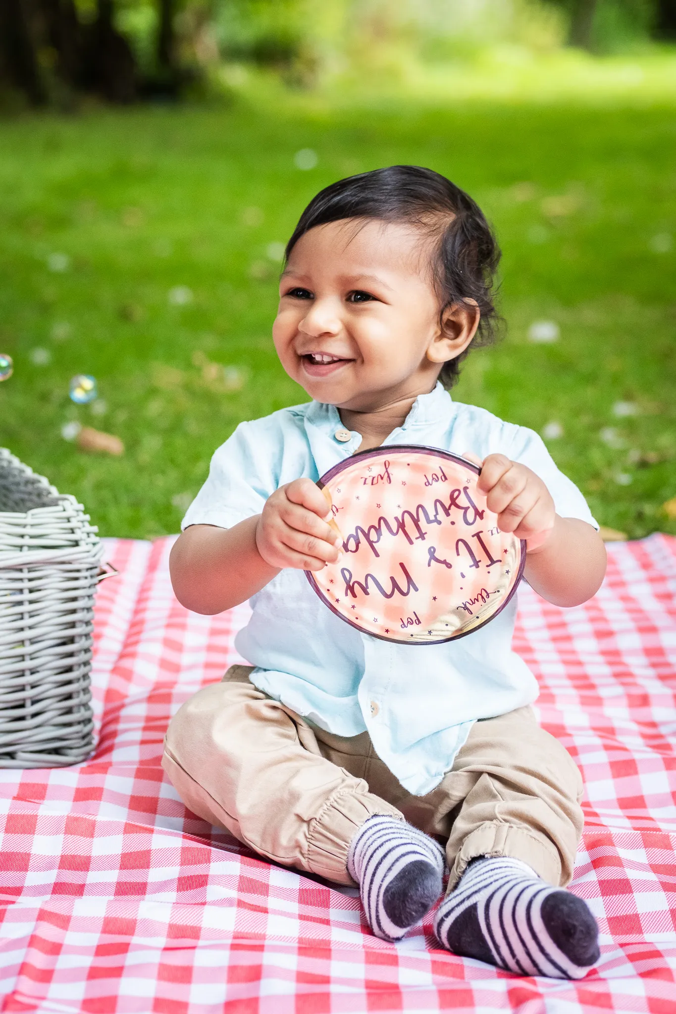 Little baby boy's first birthday photoshoot in a park