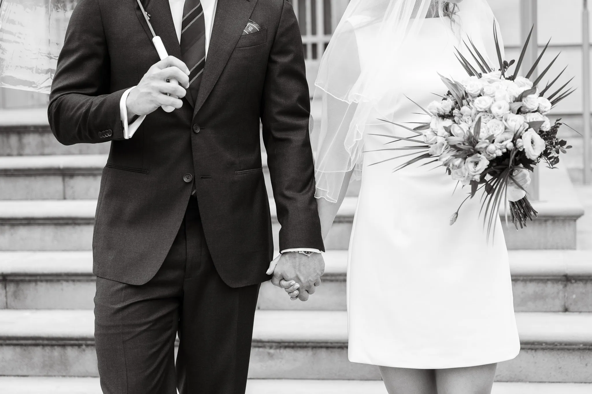 Wedding ceremony, capturing a couple getting married, groom holding an umbrella and bride with flowers
