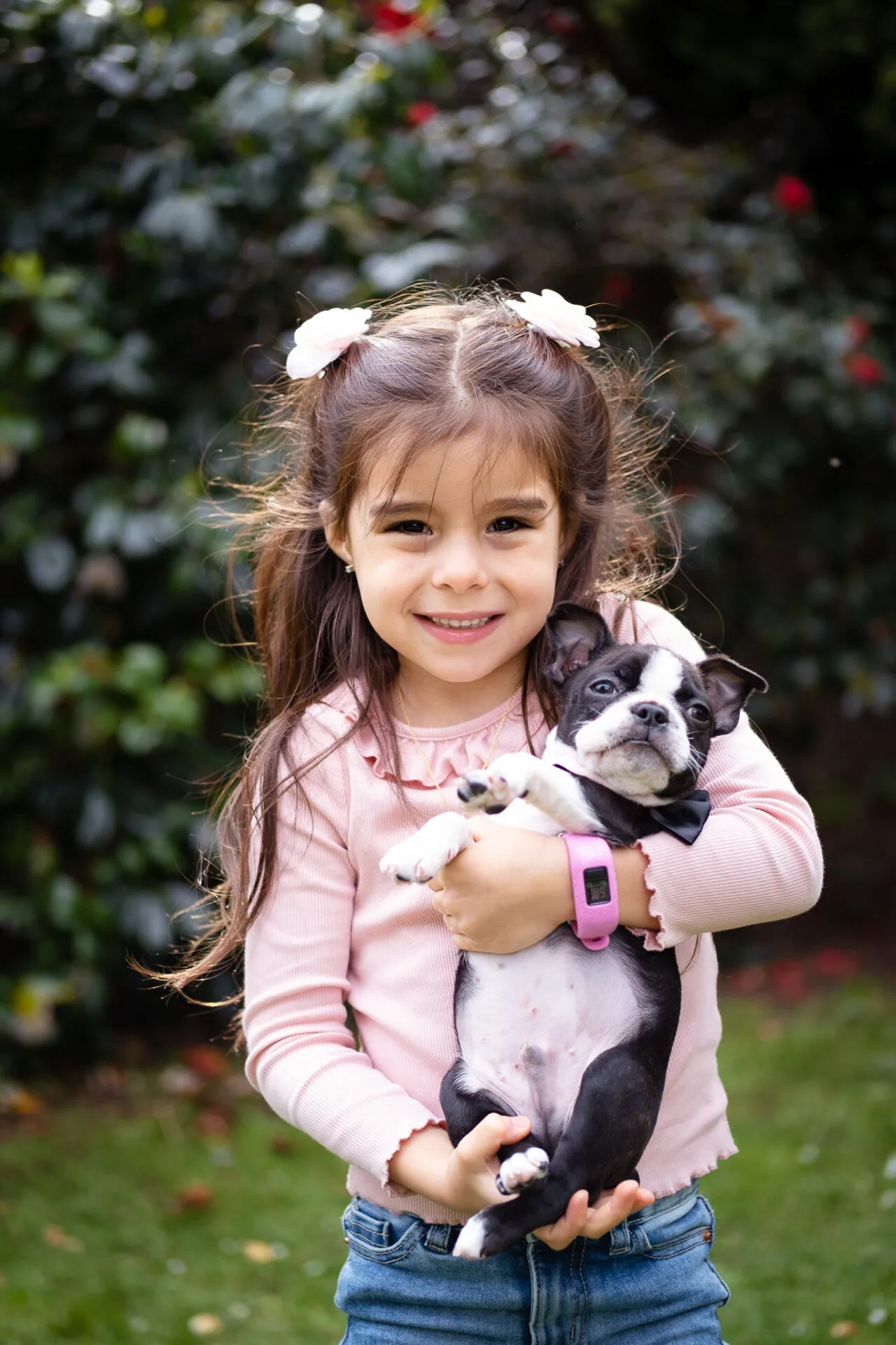 Little girl holding her puppy for a photoshoot