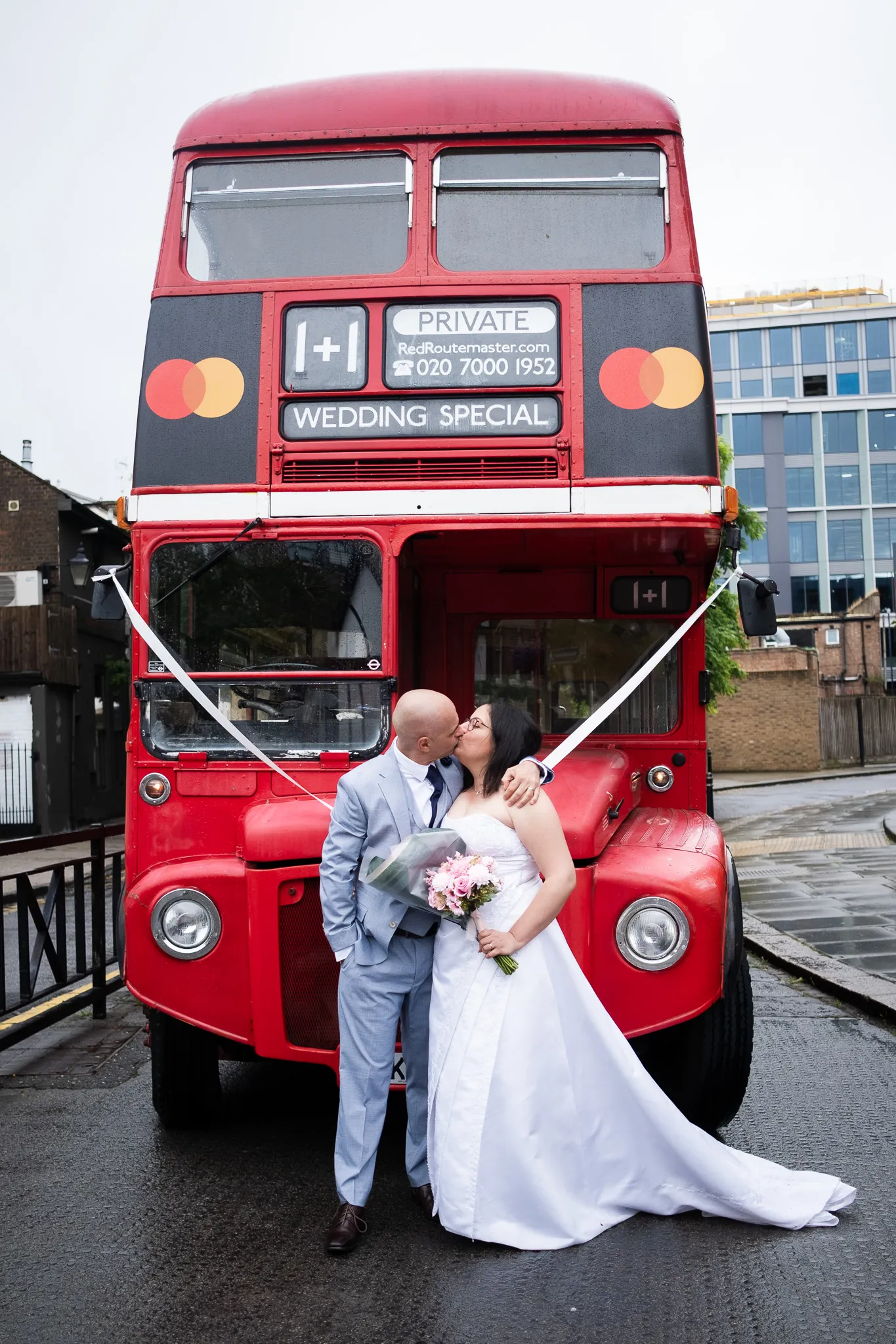 Red London Bus on groom and bride's wedding day