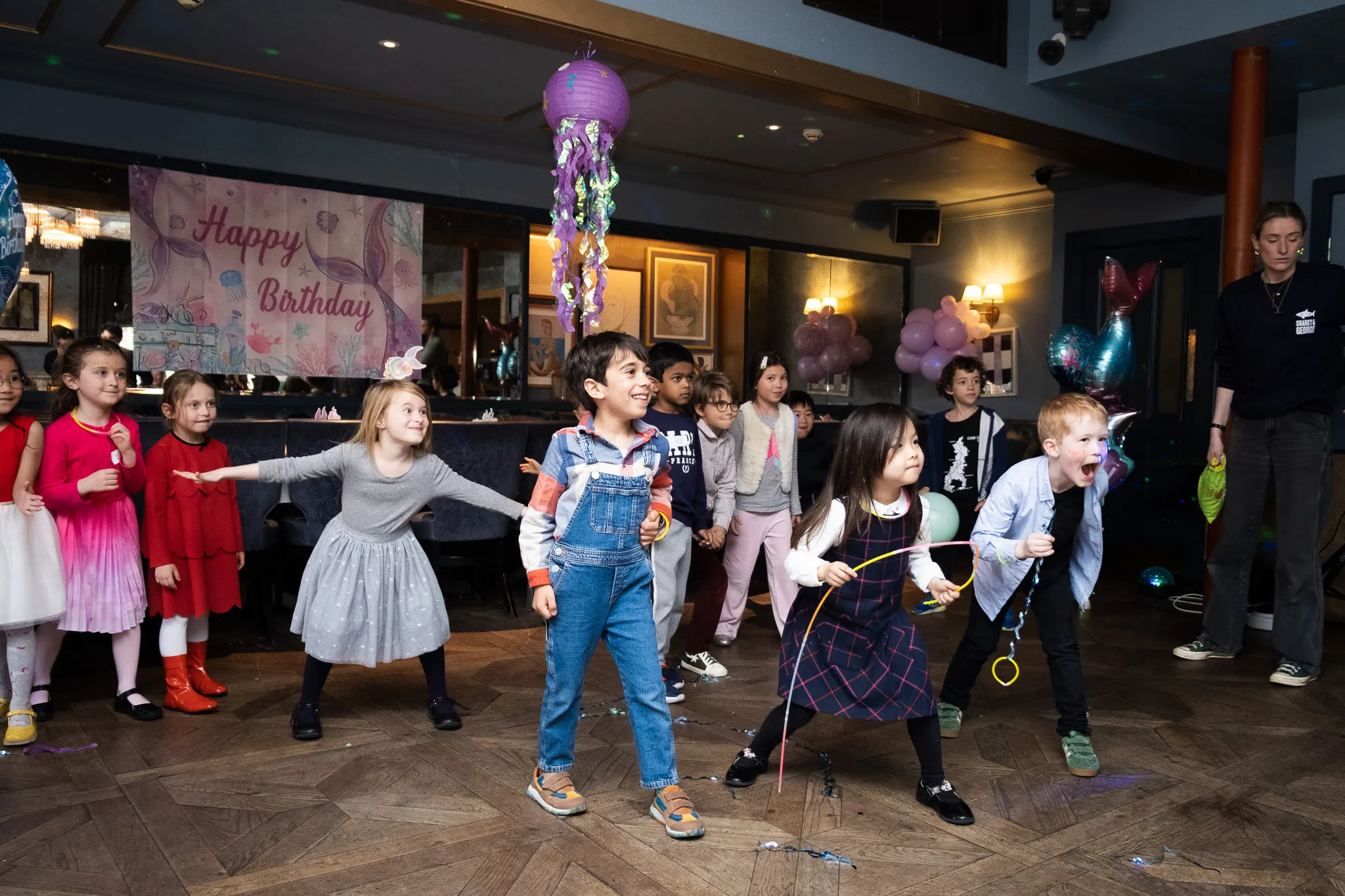 Children on a birthday party, birthday girl with her friends having fun