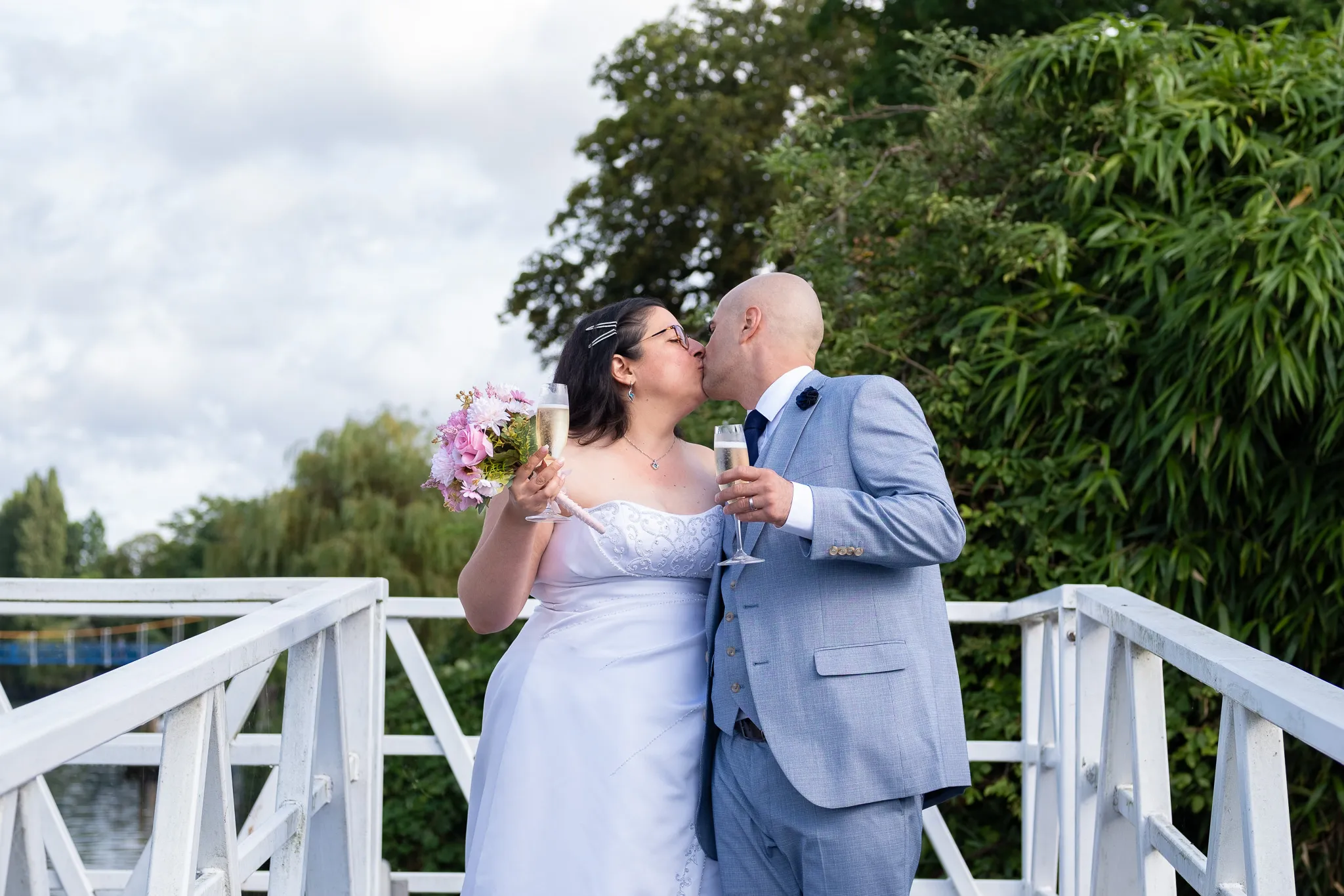 Groom and bride kissing, wedding photoshoot