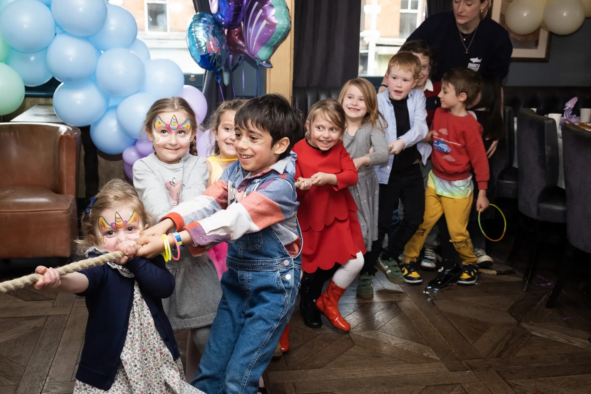 Children on a birthday party, birthday girl with her friends having fun