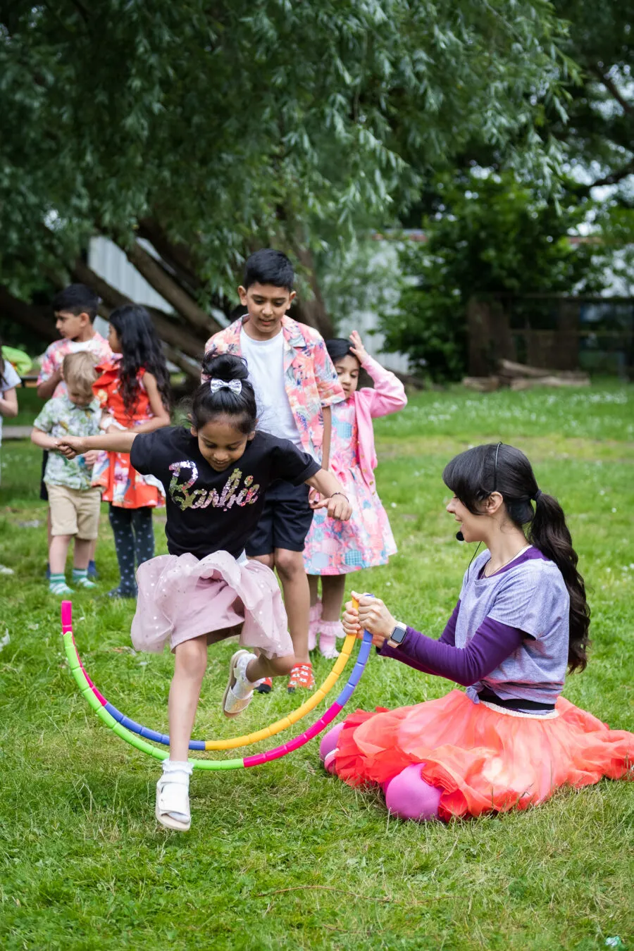 Young children jumping, playing a game on a birthday party