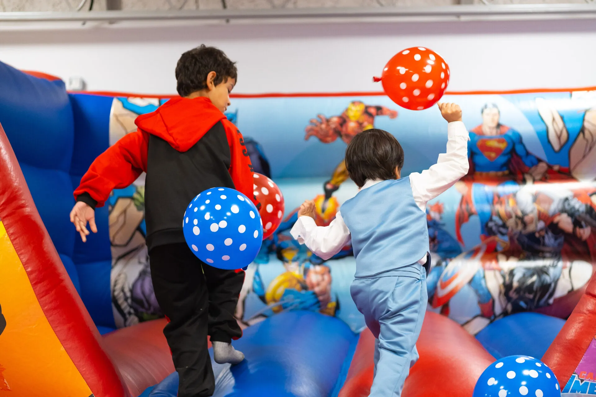 Two boys jumping on a trampoline
