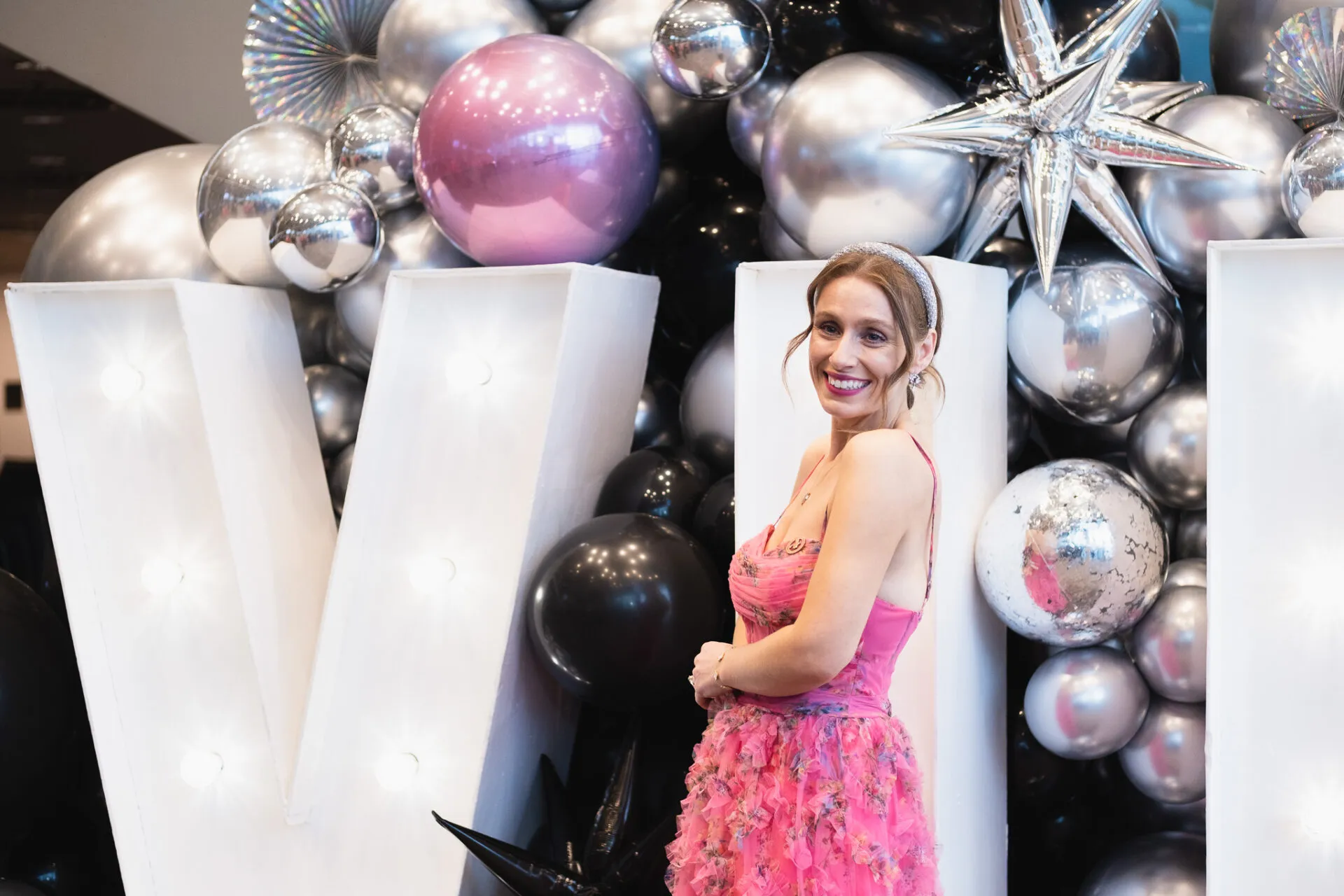 Blonde woman in pink dress on a event
