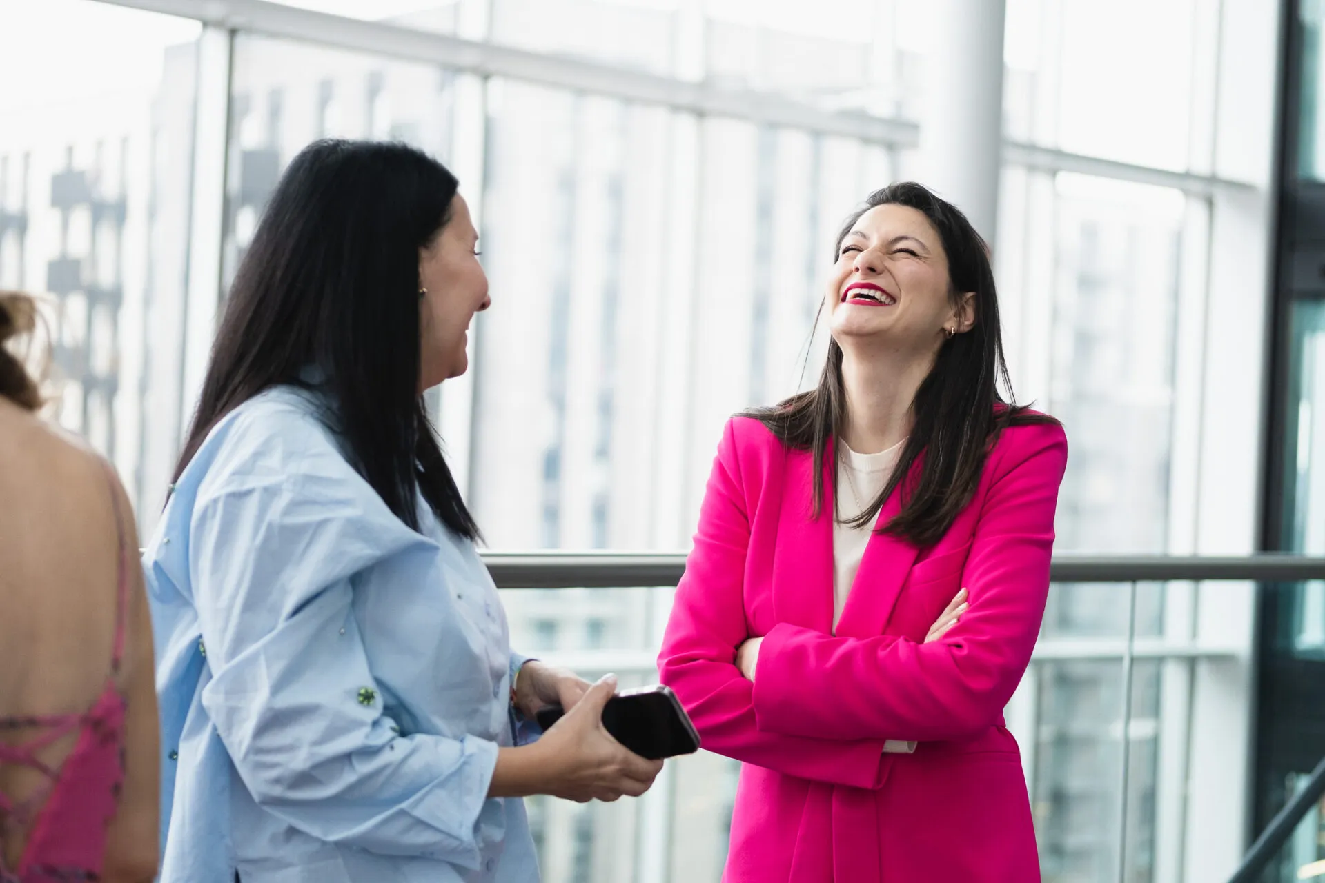 Two women talking and laughing on a beauty event
