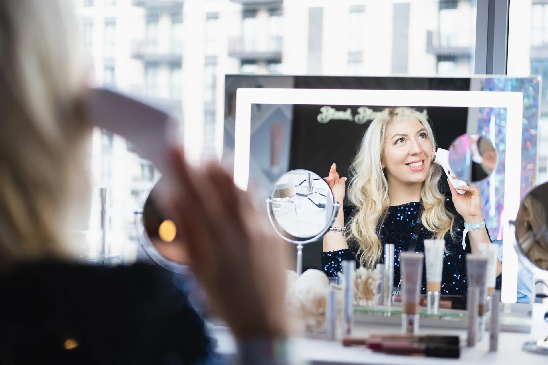Blonde lady looking herself in the mirror